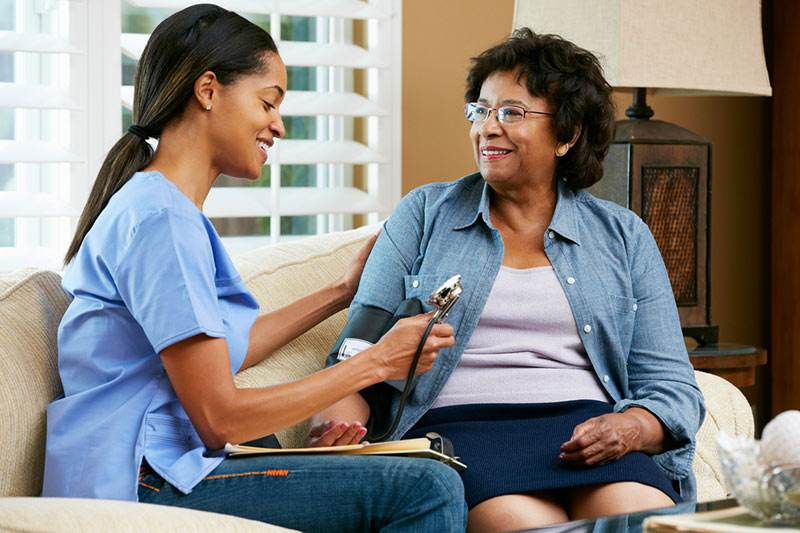 A nurse with a stethoscope checks a patient's blood pressure in Spring Lake, LA