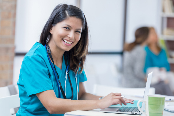 A nursing home physician in Spring Lake is working on her laptop