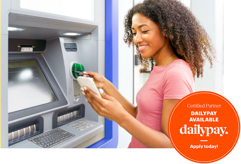 A woman uses dailypay service at an ATM in Spring Lake, LA