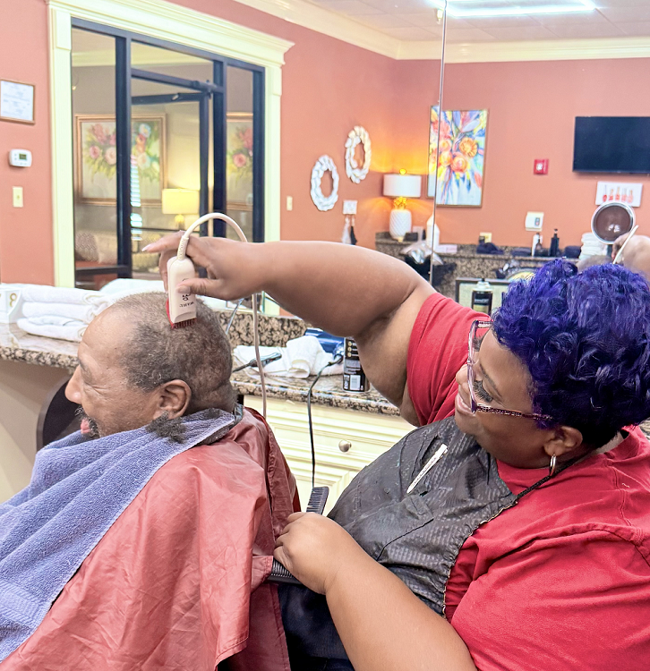 man getting haircut in on-site salon