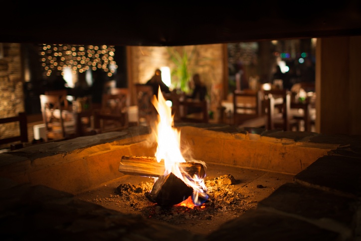 Hotel-like amenities in Spring Lake LA featuring cozy indoor fireplace and warmly lit dining area
