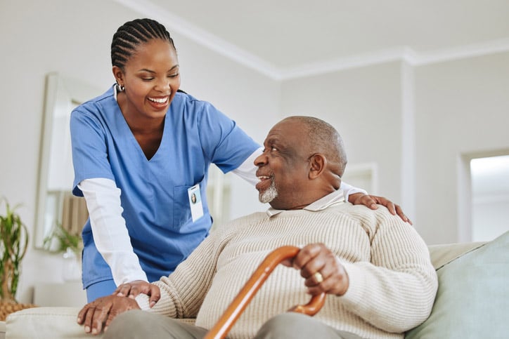 Nurse chatting with a senior man in long-term care