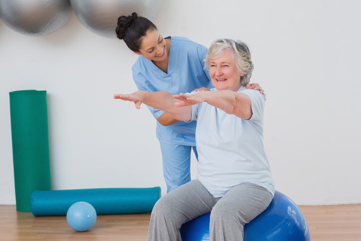 Therapist guiding a resident through rehabilitation